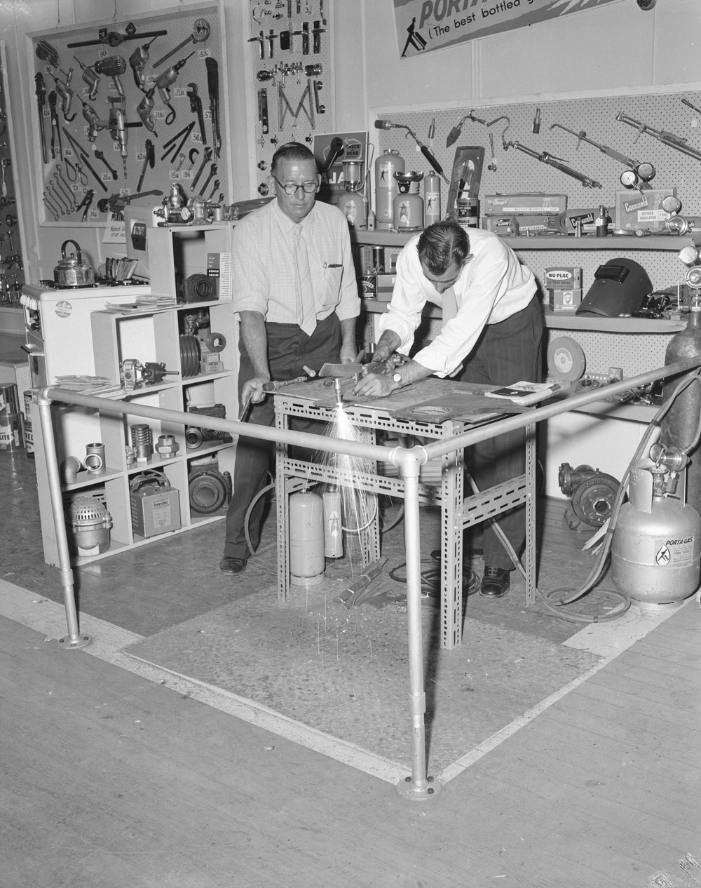 Staff demonstration at Mining &amp; Hardware Supplies Pty Ltd display stand at Ipswich Show, Ipswich, 1959