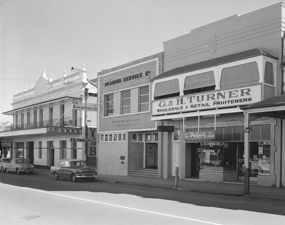 Streetscape of what was Club Hotel, Bearing Service Company, Bank of New South Wales and G &amp; H Turner; Wholesaler &amp; Retail Fruiterers - 215, 213 &amp; 211 Brisbane Street, Ipswich, 1959.