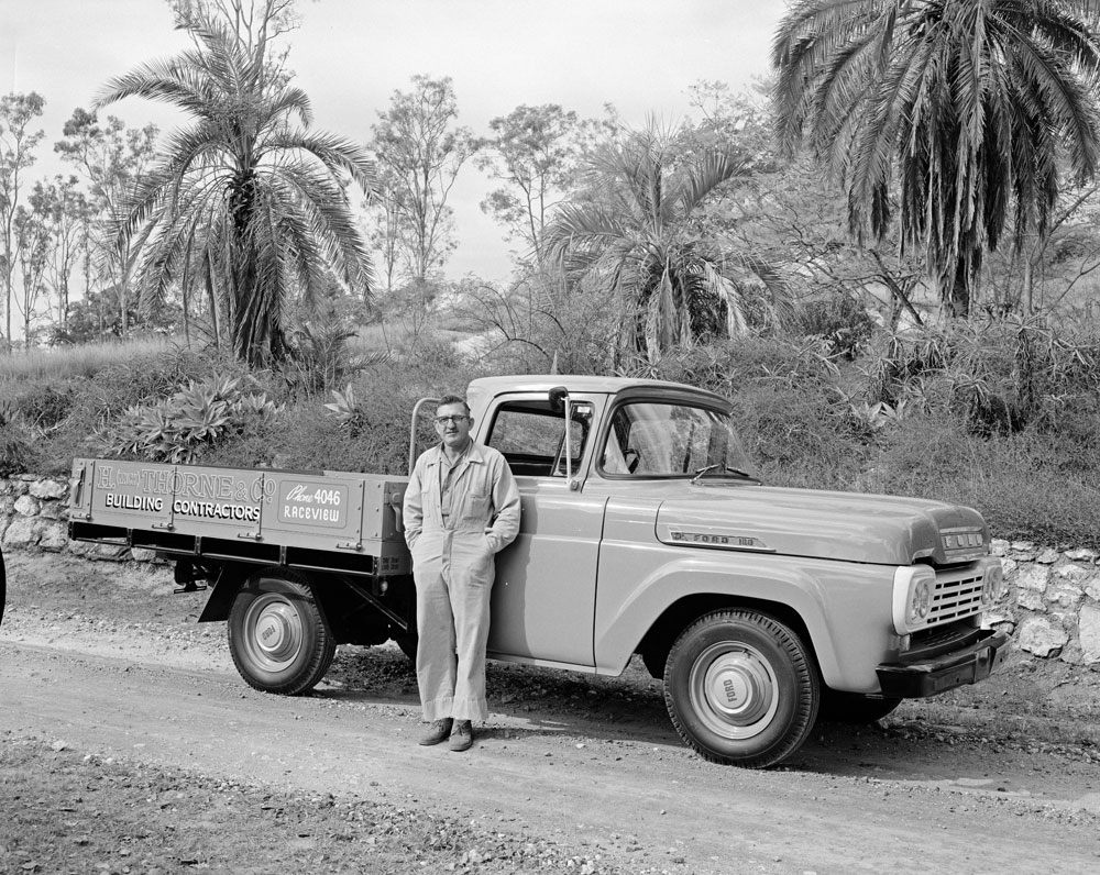Ford utility truck, with who is believed to be H. (Mick) Thorne, building contractor, in front of ute, Ipswich, 1960