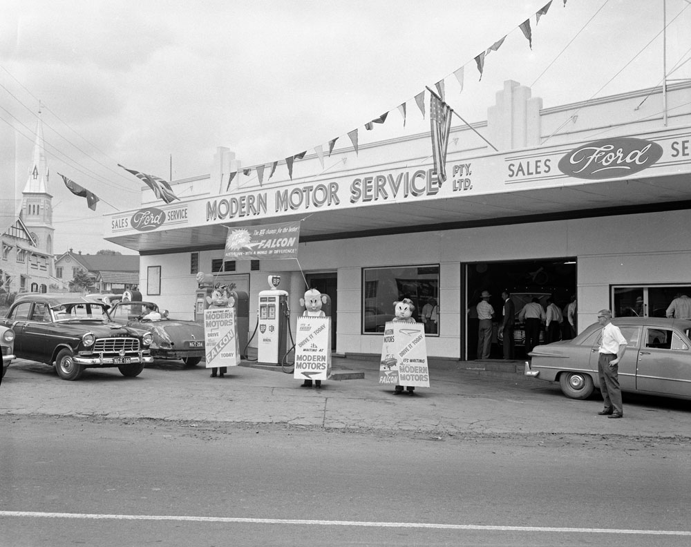 Staff of Modern Motors promoting new Falcon car, in front of business in Brisbane Street, Ipswich, 1960