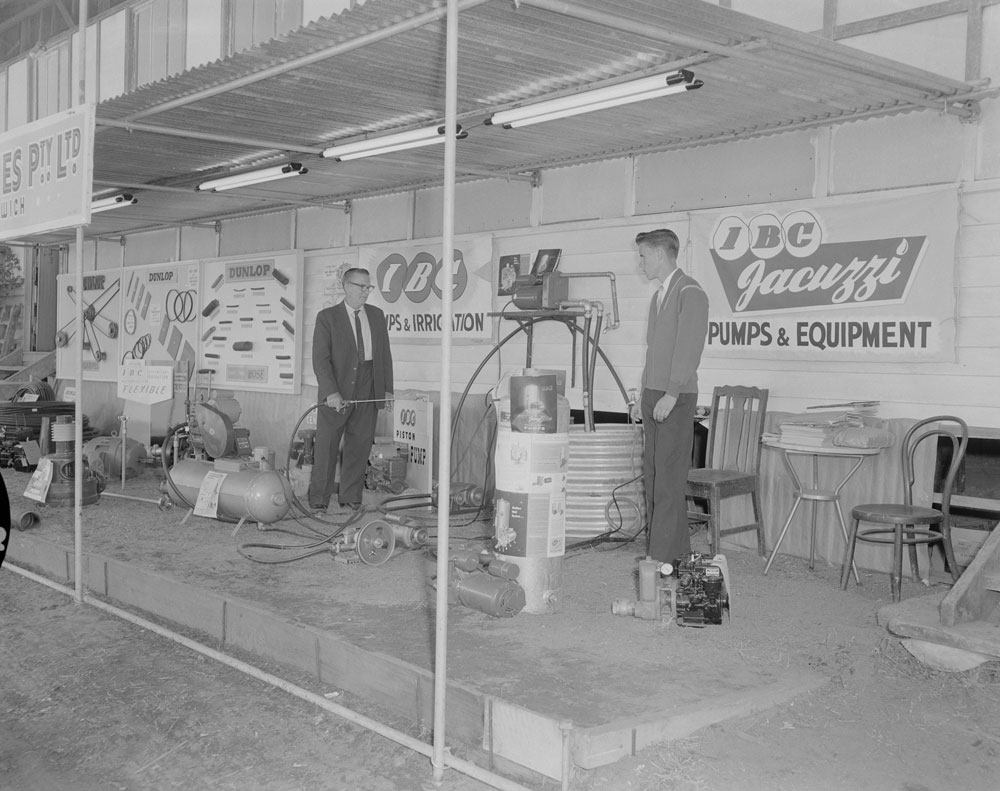 Product demonstration by staff at Mining &amp; Hardware Supplies exterior display, Ipswich Show, Ipswich, 1961