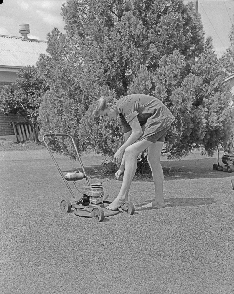 Thought to be a staff member at L.W. Griffiths with a Rover lawn mower, Ipswich, 1963