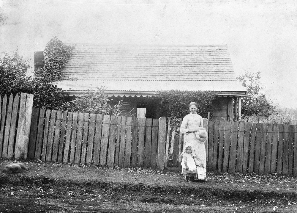 Mother and child in front of house, Ipswich,  1890s