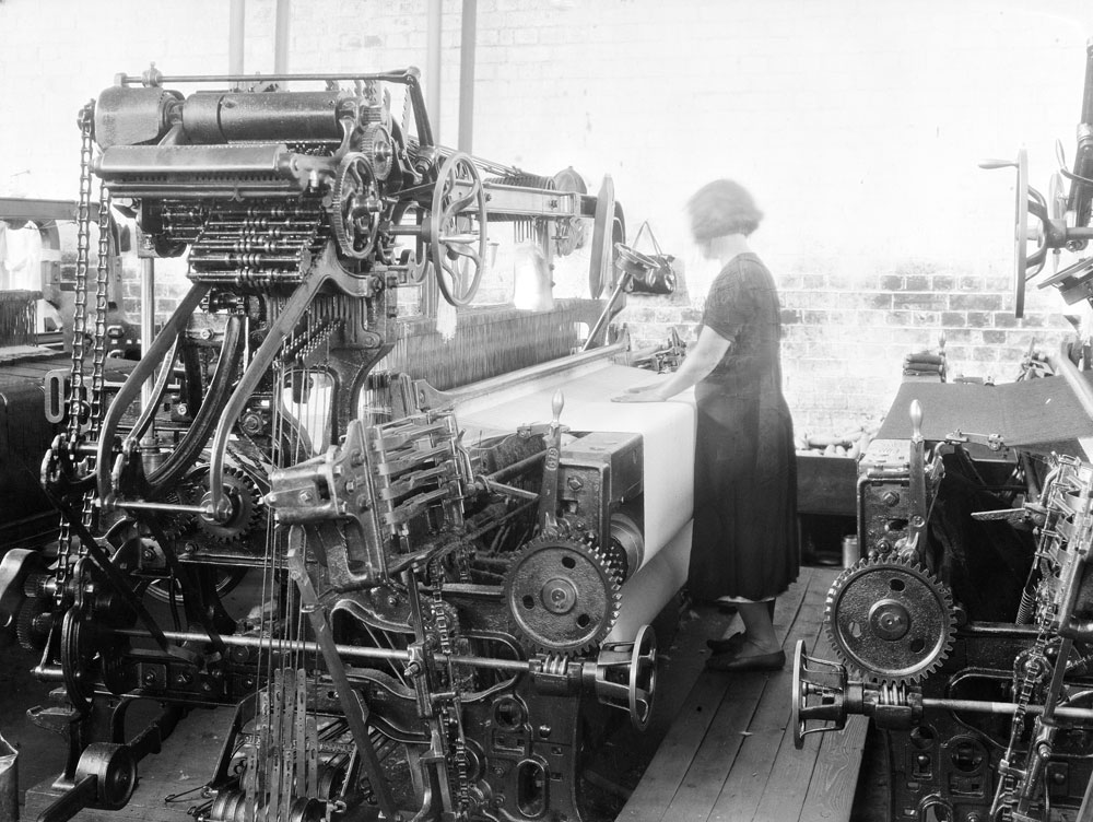 Staff working the weaving loom at the Queensland Woollen Manufacturing Company, The Terrace, North Ipswich, 1935