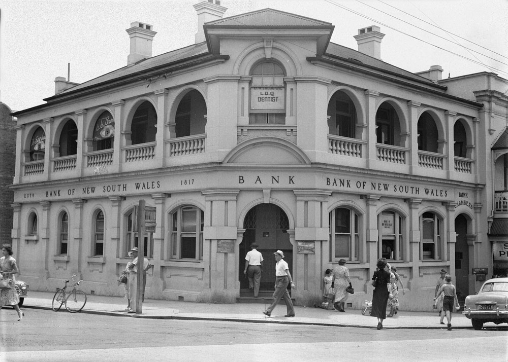 Pedestrians in front of Bank of New South Wales, corner Bell and Brisbane Streets, Ipswich, c.1950