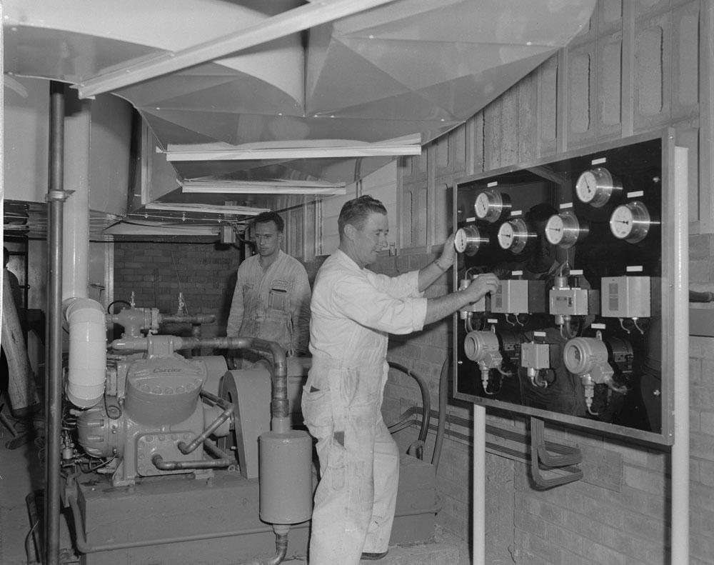 Ipswich Bowling Alley staff with air-conditioning unit, corner Brisbane and Thorn Streets, Ipswich, 1963