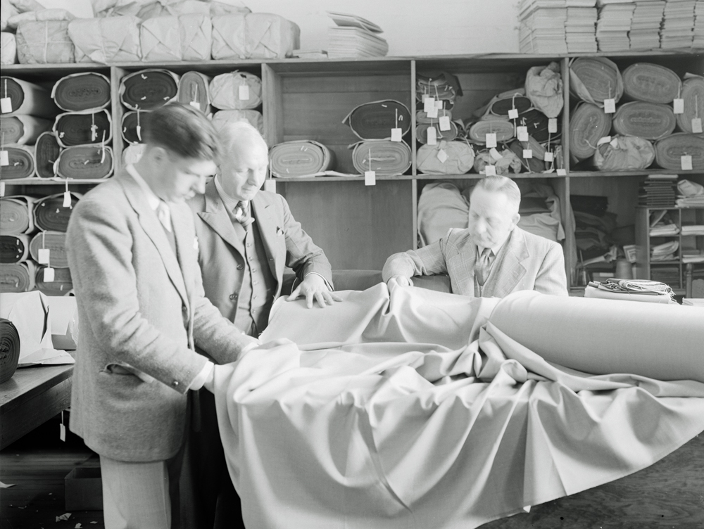 Examining fabric, Ipswich Woollen Mills, Joyce Street, East Ipswich, 1956