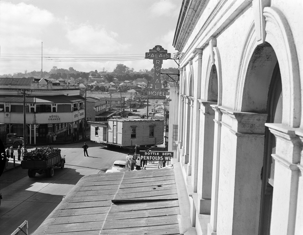 House removal travelling through town, Brisbane Street, Ipswich, 1957