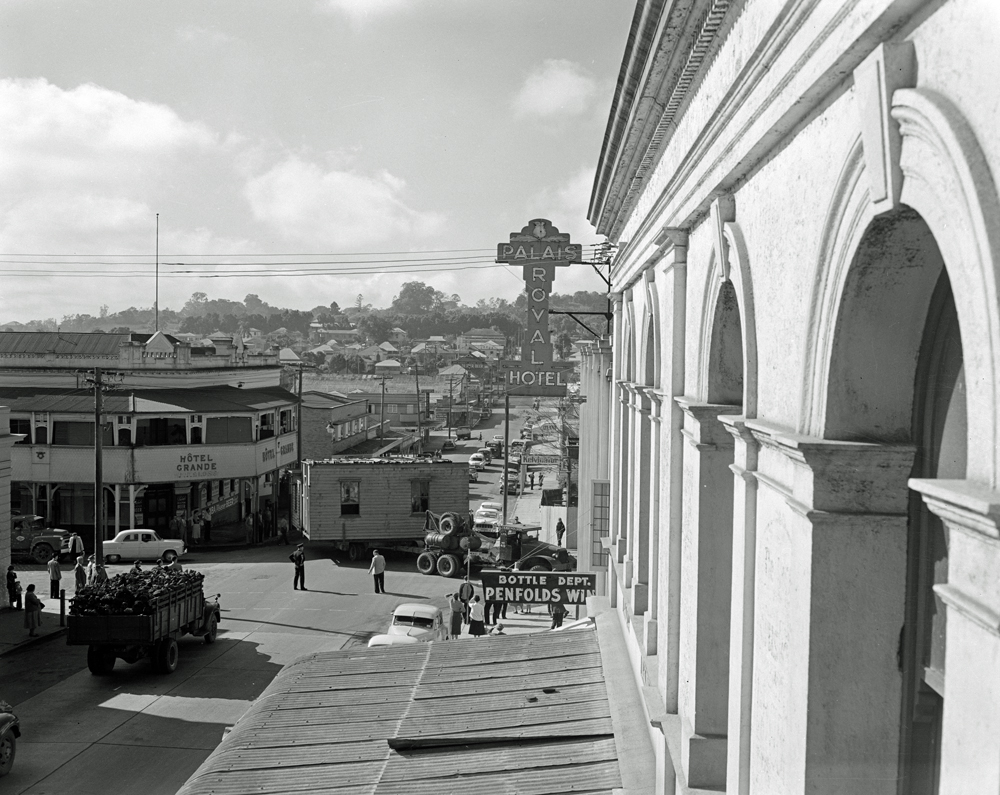 House removal travelling through town, Brisbane Street, Ipswich, 1957