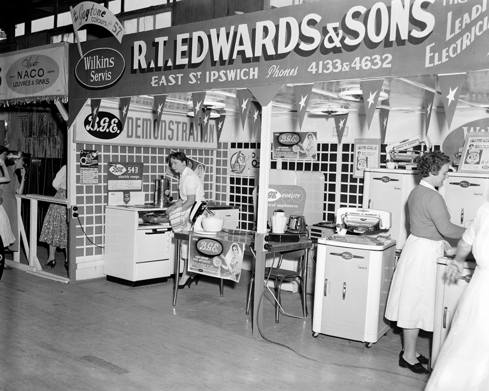 Staff demonstrating electrical appliances at the R T Edwards &amp; Sons electrical appliance display stand at the Ipswich Show, Ipswich, 1957