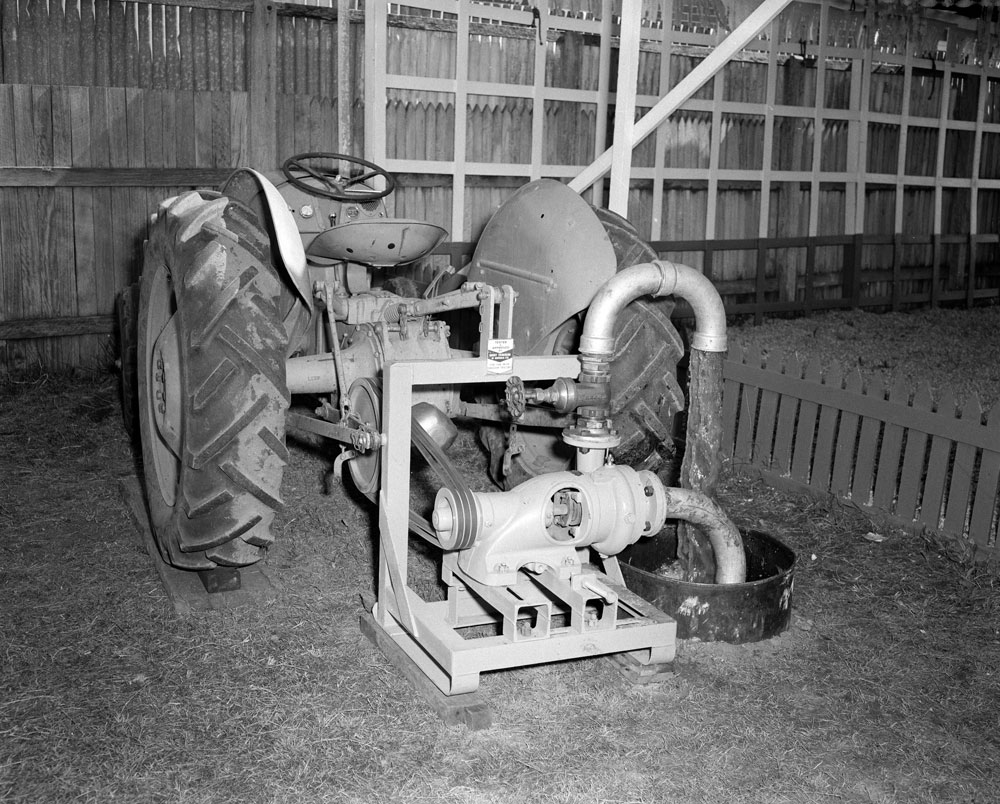 Display of a Ferguson tractor pumping water at the Cribb &amp; Foote Motors display, Ipswich Show. Ipswich, 1958