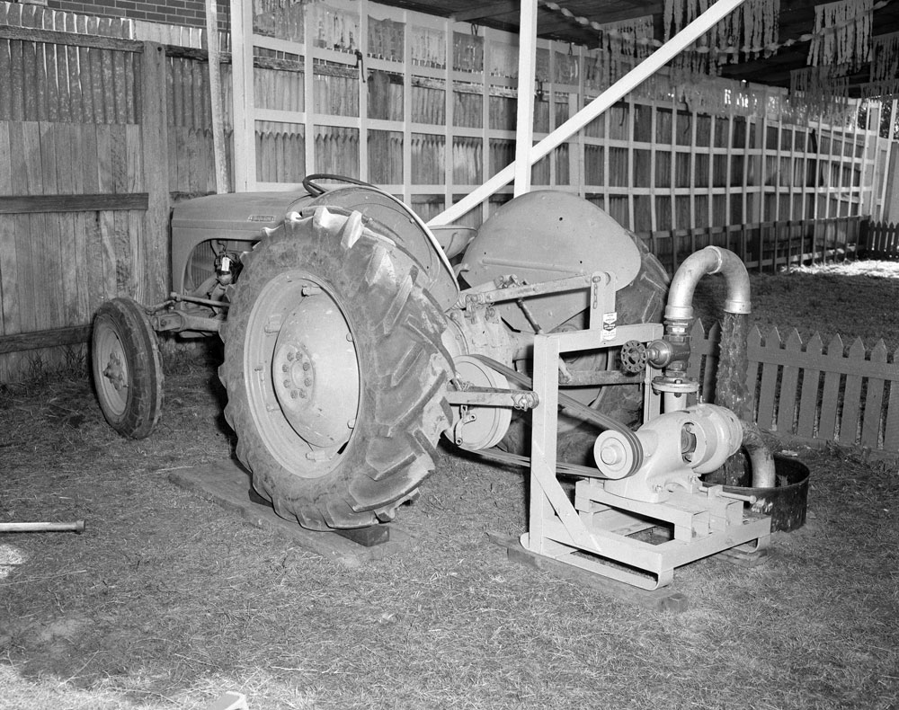 Display of a Ferguson tractor pumping water at the Cribb &amp; Foote Motors display, Ipswich Show, Ipswich, 1958
