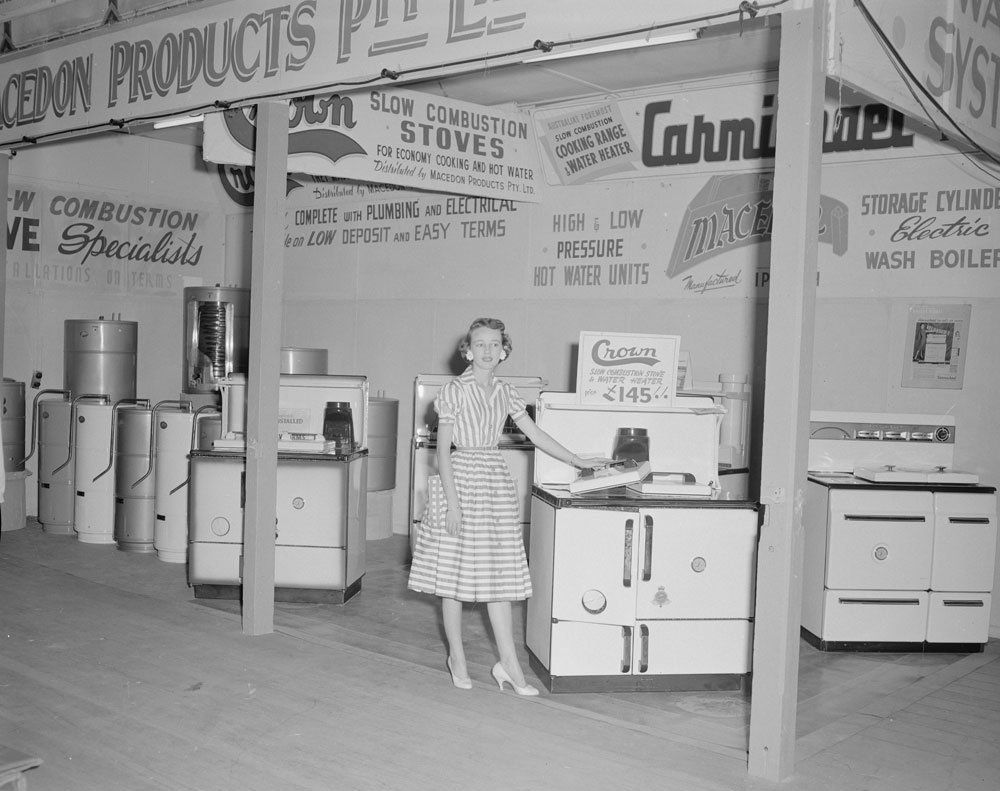 Macedon Products staff member at their display, Ipswich Show, Ipswich, 1958