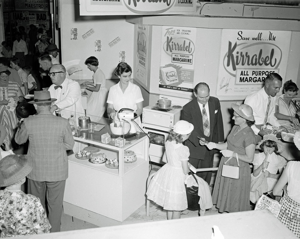 Staff and crowds at the Kirrabel All Purpose Margarine display, Ipswich Show, Ipswich, 1958
