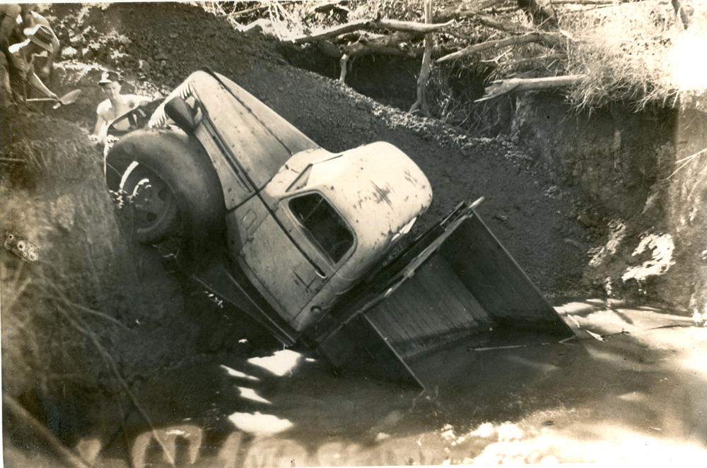 Truck, owned by W.A. Hughes Pty. Ltd.  in a hole at Rhondda Coalmine, Blackstone, Ipswich, c.1940s