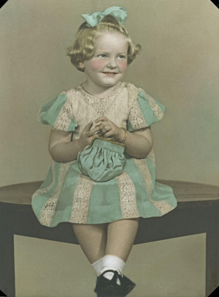 Portrait of a young girl in a lace and cotton dress, Ipswich, 1947
