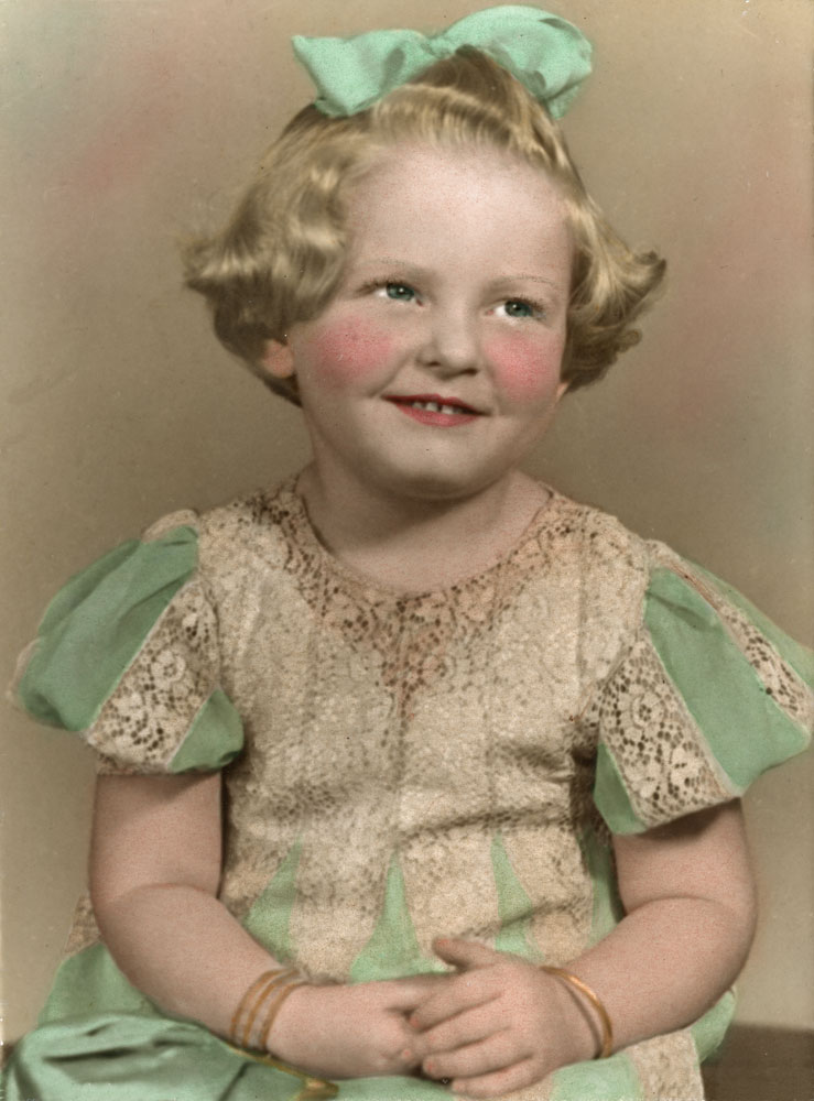 Portrait of a young girl in a lace and cotton dress, Ipswich, 1947
