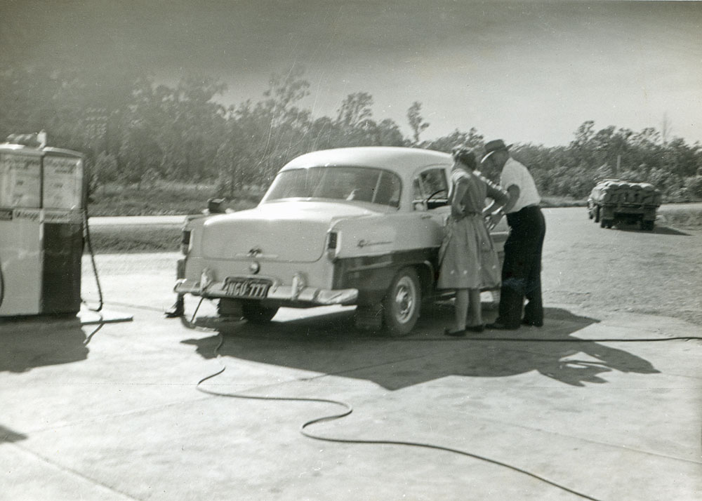 Holden car in front of petrol pump at the Blue Star Service Station, Warrego Highway,Blacksoil, Ipswich, 1958