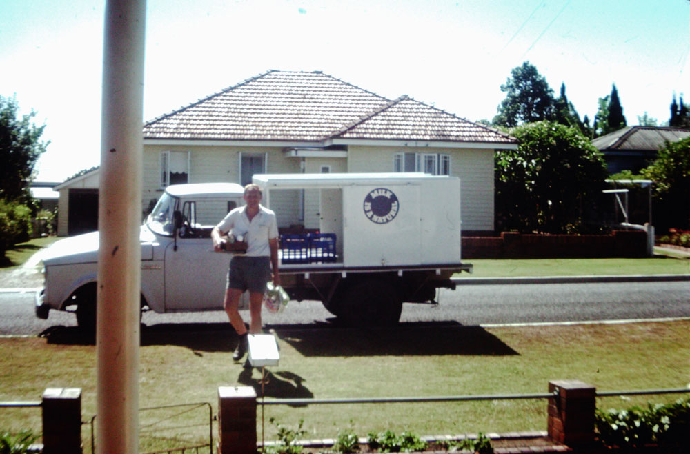 Denis Dargusch beside his milk truck, Silkstone, Ipswich|Ipswich, Queensland, early 1960s