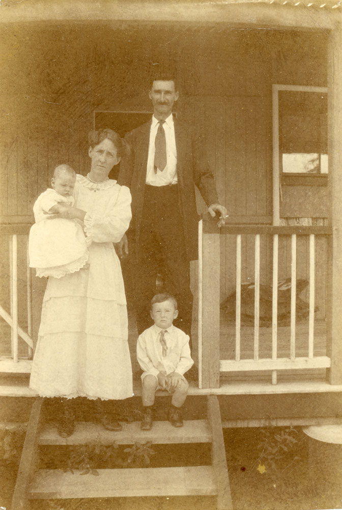 William and Lizzie Bere with their two sons on veranda of home at 9 Weldon Street, North Ipswich, 1922