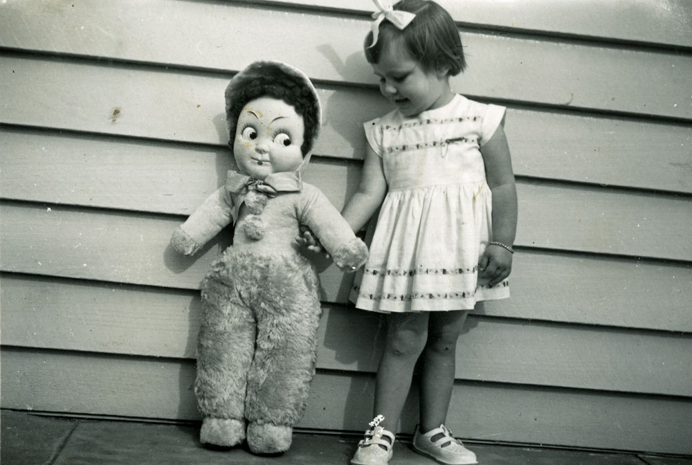Child with Big Betsy doll, on her 3rd birthday, Booval, Ipswich 1959