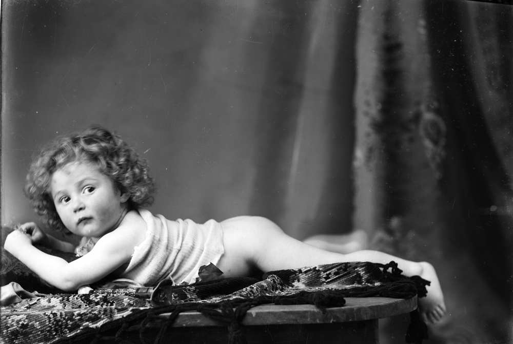 Unidentified baby (possibly Barnett family) on Rug, I.X.L. Studios, Ipswich, 1900s