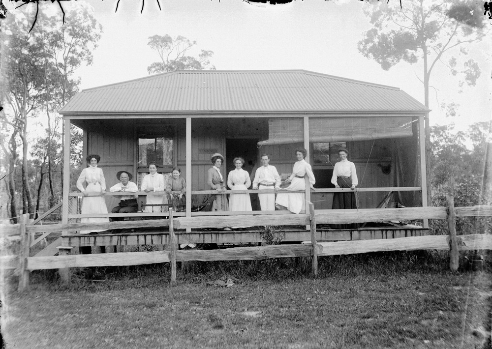 Group standing on veranda of St Mungo, thought to be a holiday home at Margate, Moreton Bay, 1900s