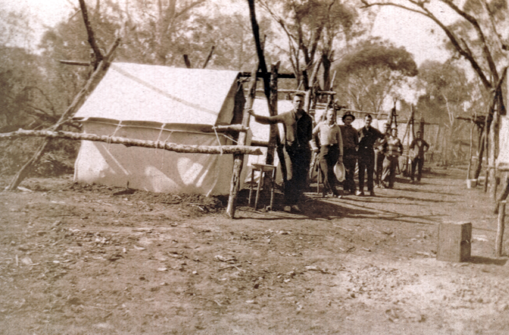 Group of men, in front of their tents, during land clearing, as part of a 'Work for the Dole' scheme, Death Adder Gully, Chinchilla, Queensland 1932