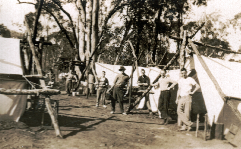 Group of men, in front of their tents, during land clearing, as part of a 'Work for the Dole' scheme, Death Adder Gully, Chinchilla, Queensland 1932
