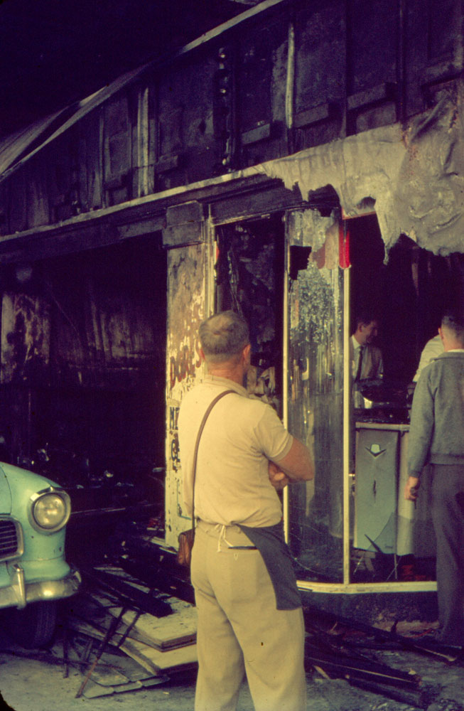 Workers at the aftermath of fire at Russ Dore Mercury Centre Showroom, Brisbane Street, Ipswich, 1963
