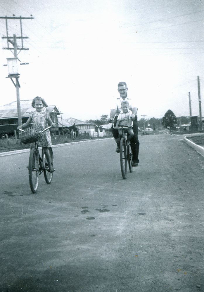 Family riding bikes near the corner of Hunter and Loynes Streets, Brassall, Ipswich, c.1956