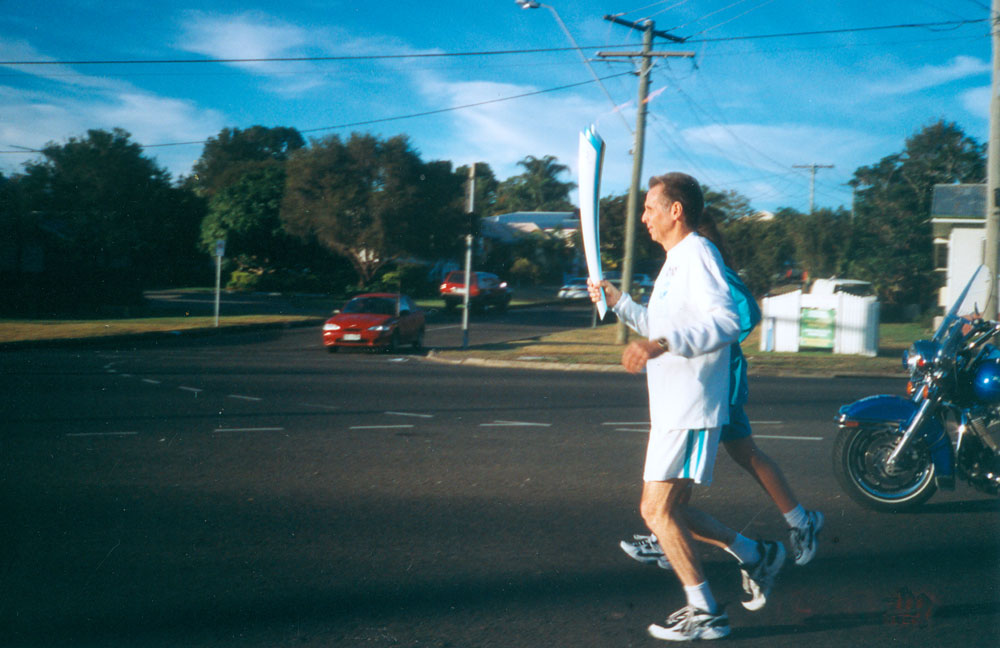 Olympic torch bearer on Brisbane Road, Booval, Ipswich, 2000