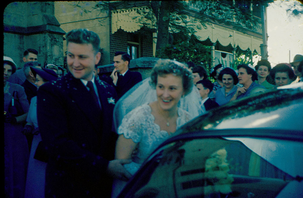 Wedding party in front of Uniting Church manse, Ellenborough Street, Ipswich, 1954