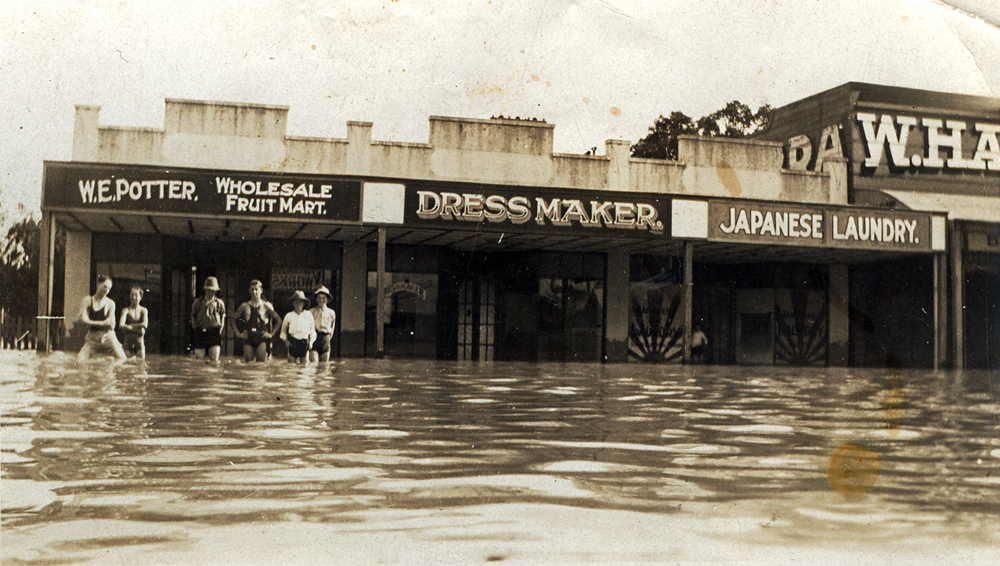Men standing in flood water, Brisbane Street, Ipswich, c.1931