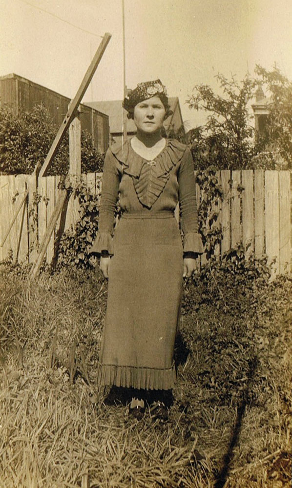 Thought to be Elizaeth Hazel Dobbie, in backyard of home, Booval, Ipswich, c.1920s