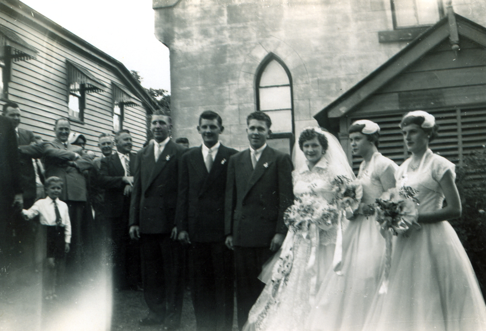 Bridal party of Ailsa and Evan Draham, in front of the Lutheran Church, Nicholas Street, Ipswich, 1956