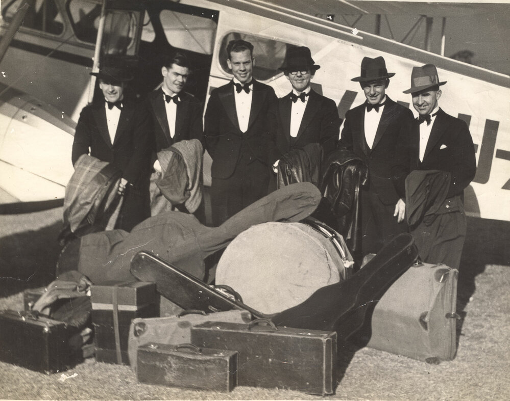 Members of Nitelites Band in front of Dragon Moth plane that took them to Jandowae, Archerfield, Brisbane