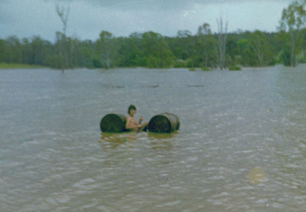 Young man making the most of the flooded Bremer River, Ipswich, during 1974 flood