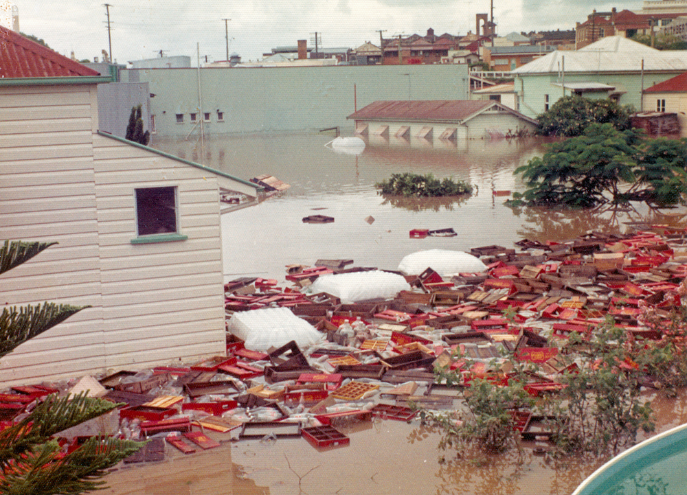 Debris from McMahons Soft Drinks Factory, Ipswich, during flood of 1974