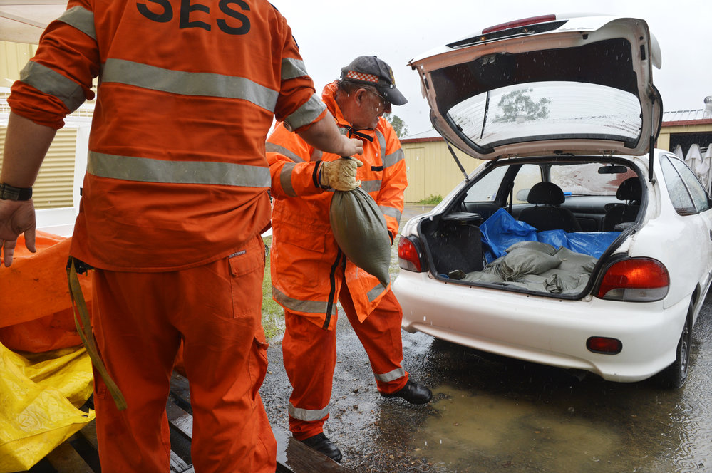 SES volunteers loading sandbags into a car, SES Depot, Ipswich, January 2013
