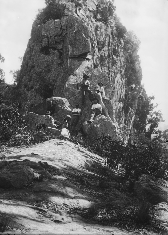 Men on rock with axes, unidentified location, Queensland, 1900s