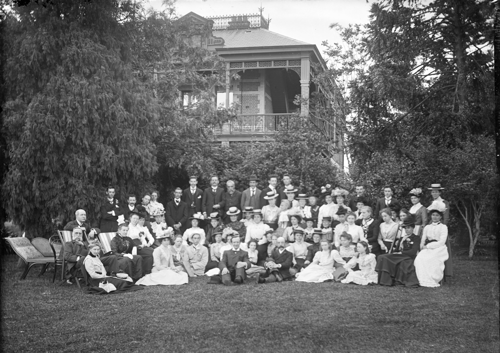 Large group in garden, corner of house in background, Launceston, Tasmania, c.1900