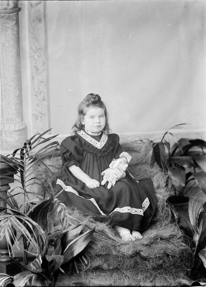 Studio portrait of young girl with doll, I.X.L. Studios, Ipswich, 1900s