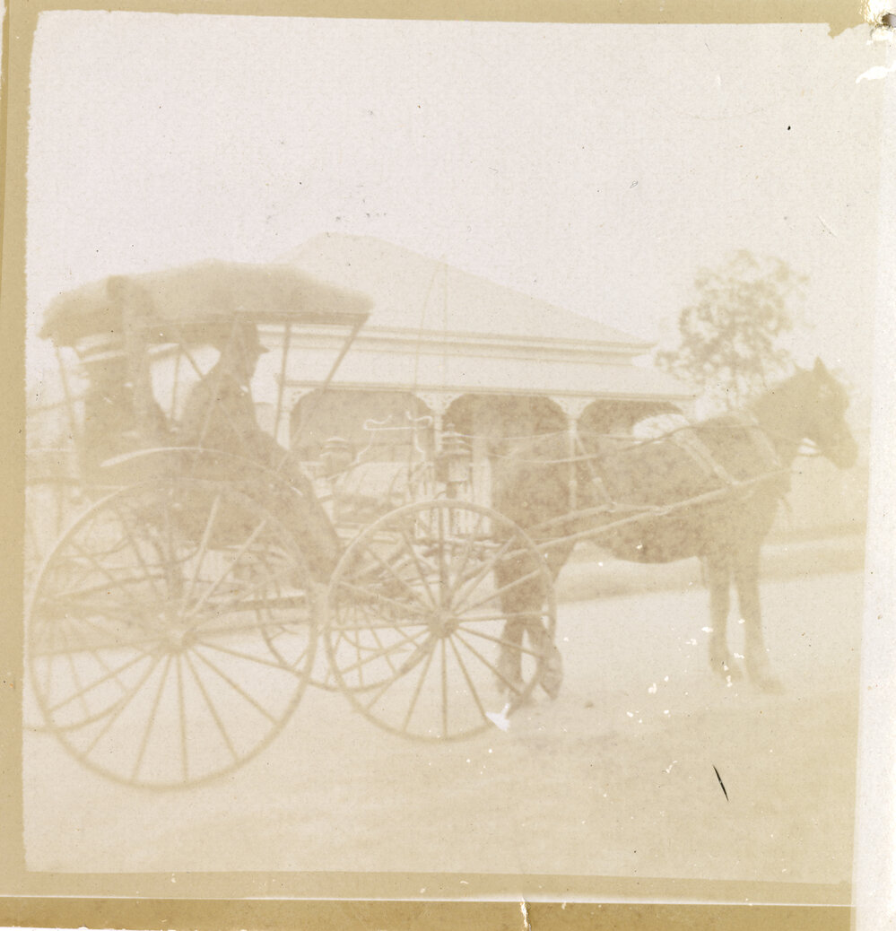 Couple in horse-drawn drop-front Phaeton in front of Ipswich residence, c.1900-1905