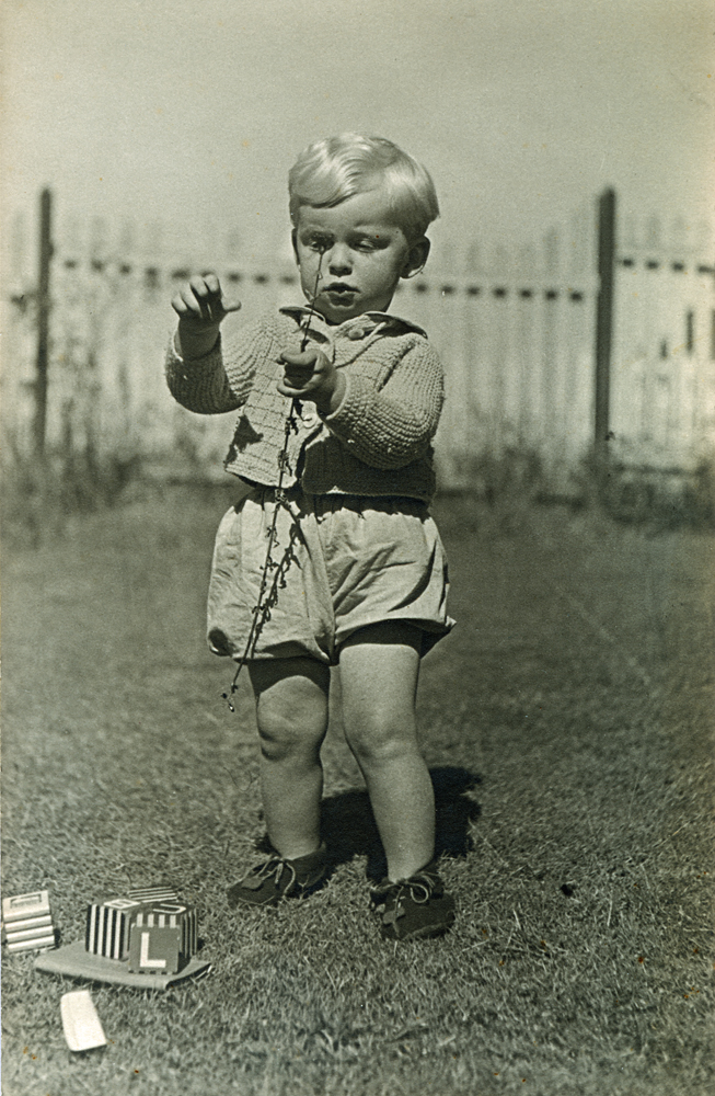 Unidentified child playing with toys, Ipswich, c.1942