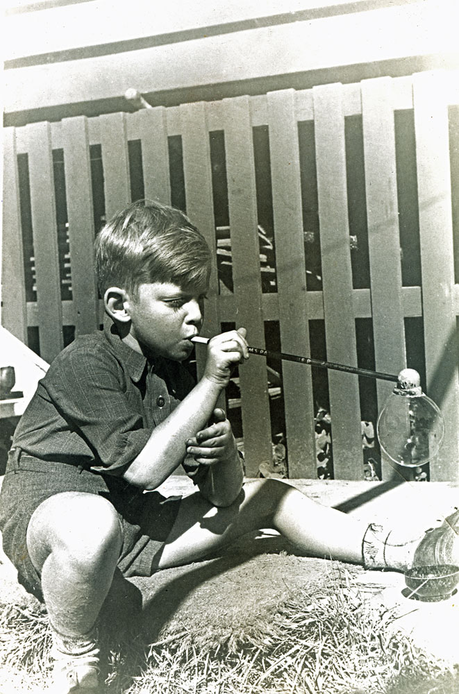 Unidentifed child blowing bubbles through pipe, Ipswich,  c.1947
