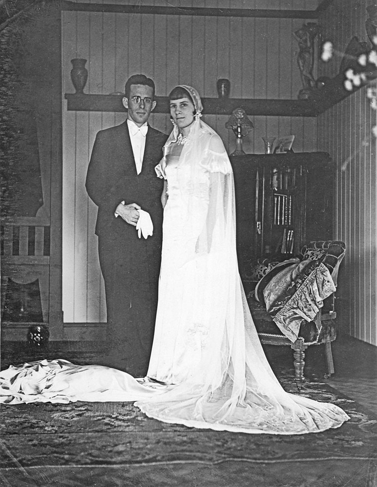 Unidentified bride and groom, in lounge room of home, 1920s