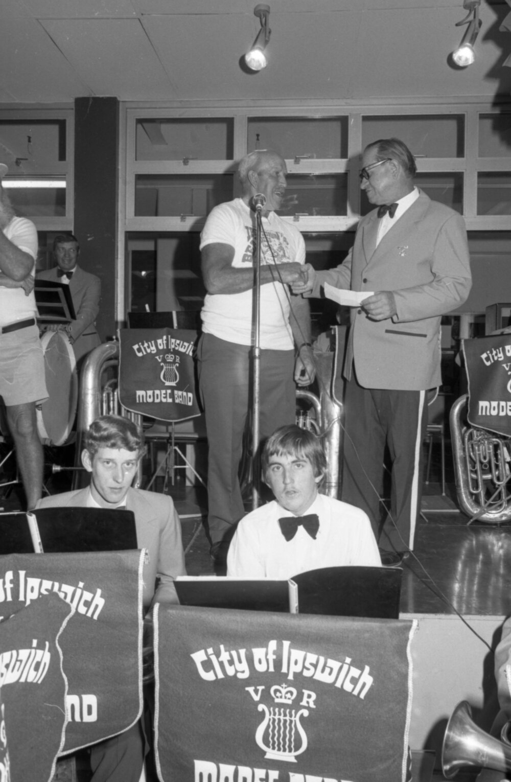 Ipswich Beardies awarding a cheque to the Ipswich Vice-Regal Model Band on the Ipswich Vice-Regal Model Band stage at Booval Fair during the Ipswich Colour Festival, Booval, August 1980