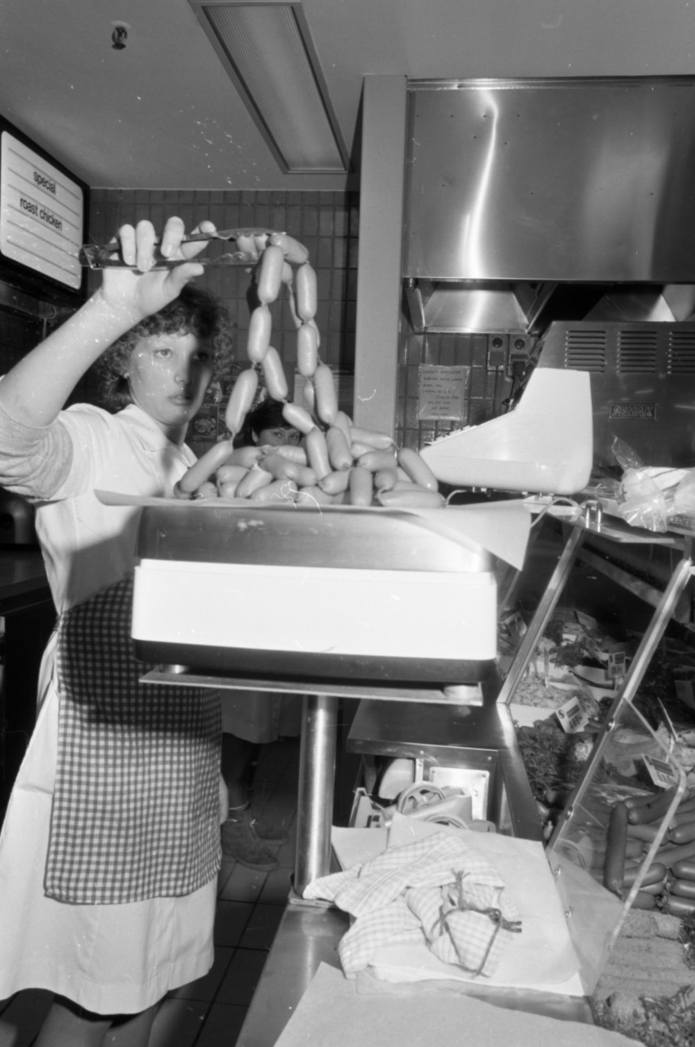 Worker at Safeway Store deli counter, Ipswich, September 1981