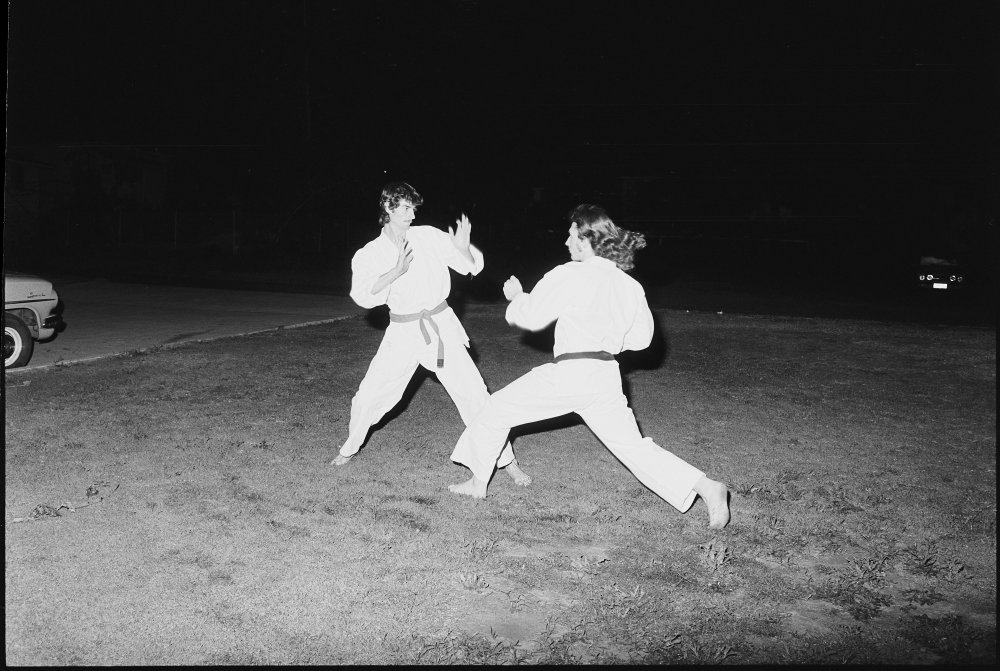 Two unidentified men practicing karate wearing traditional gi, Ipswich, October 1980